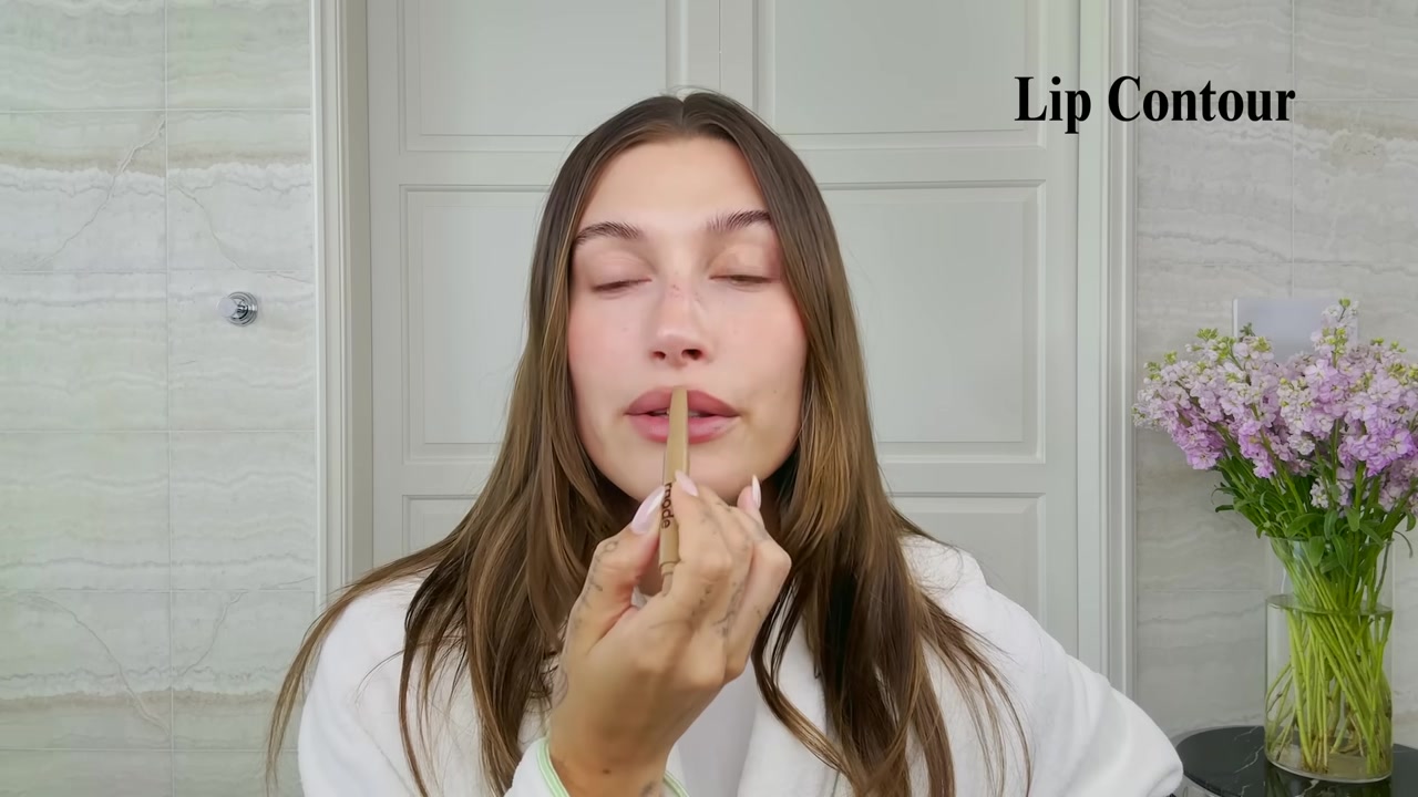 Hailey Bieber demonstrating trace the natural lip edge