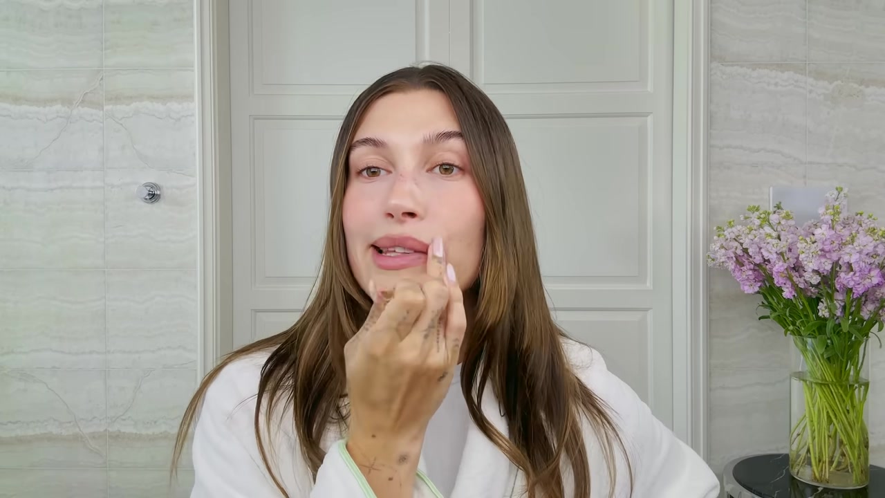 Hailey Bieber adding lip contour along the lower lip